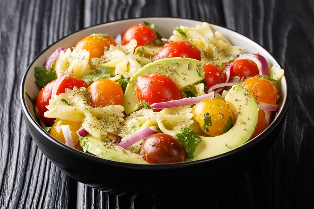 homemade pasta sald with onion, red onions, tomatoes, avocados