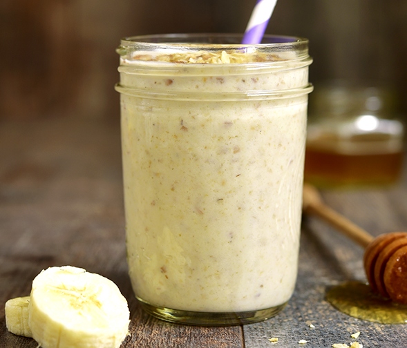 Oats in a jar with soy milk bananas and honey. 