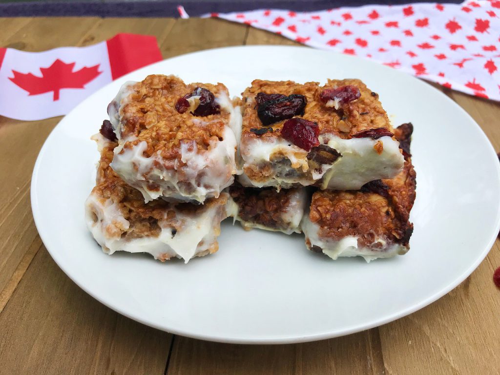 homemade granola bars made from oats, wheat bran, dried cranberries and dipped into a homemade yogurt.