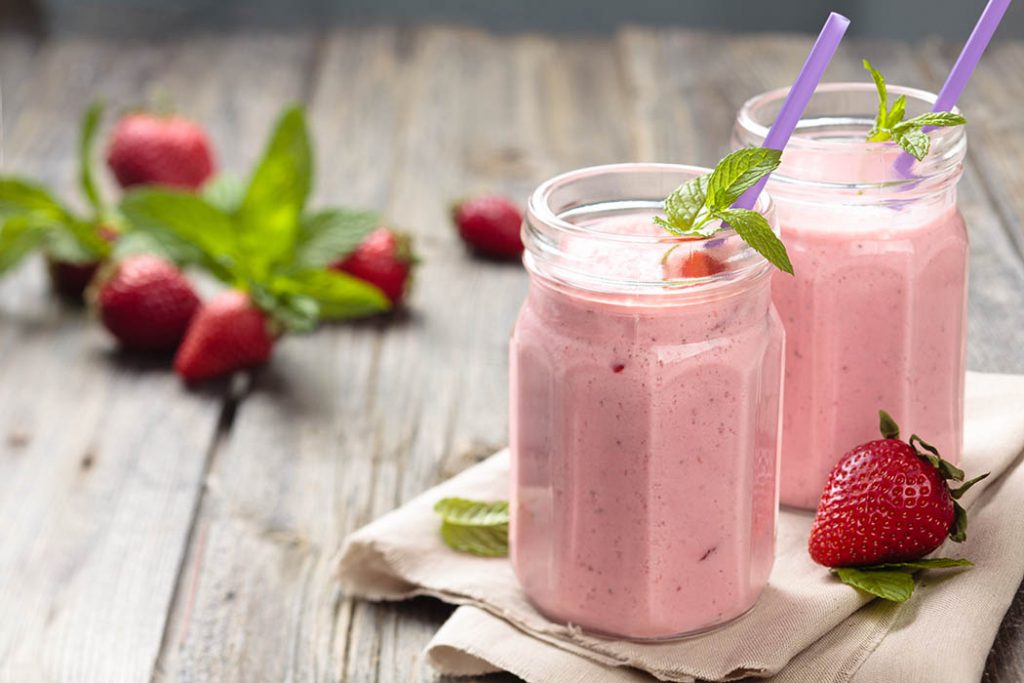 Two jars of homemade soy milk smoothie made from soy milk cream with fresh berries. 