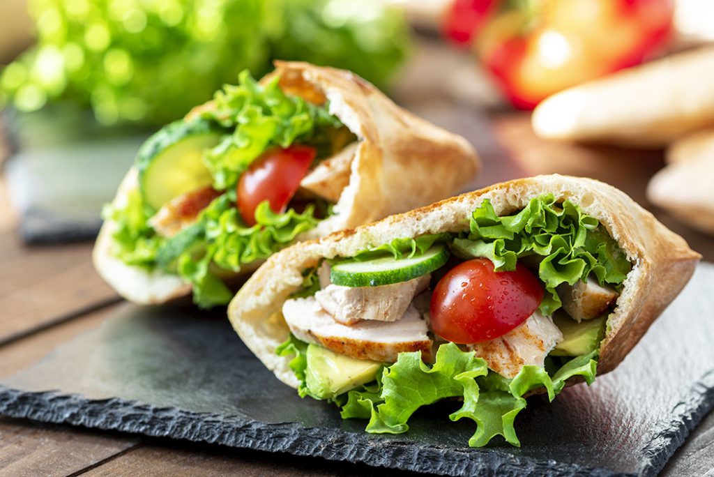 whole wheat pita stuffed with chicken and fresh vegetables.