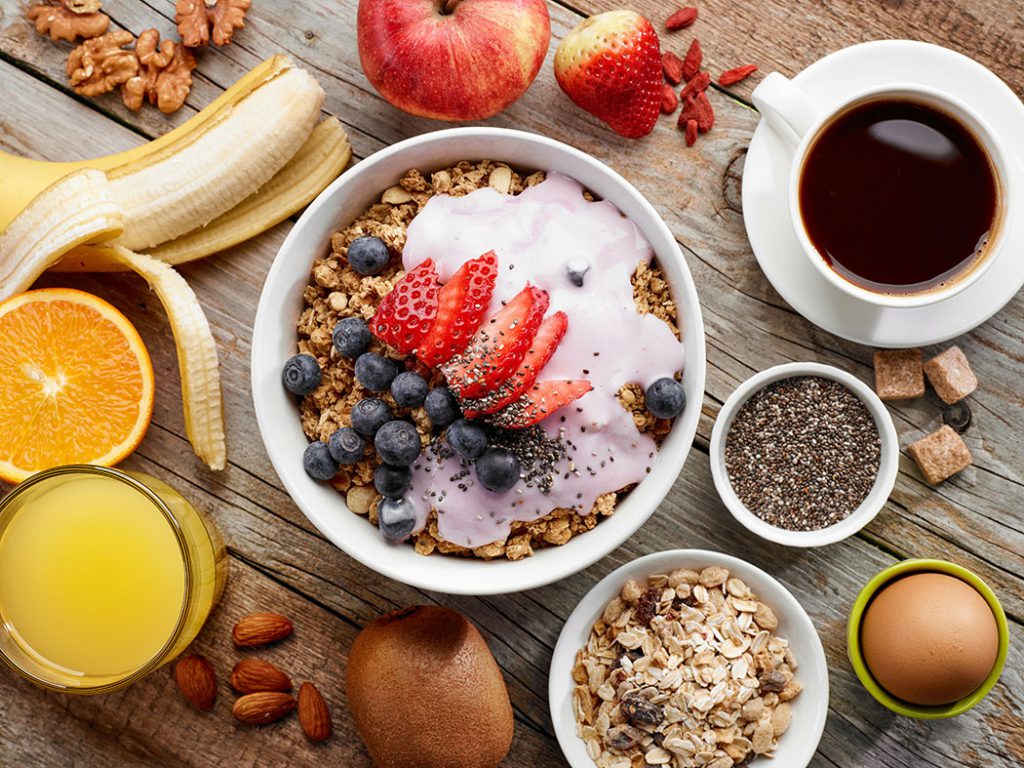 healthy breakfast spread featuring fruits, grains, berries, eggs and nuts. 