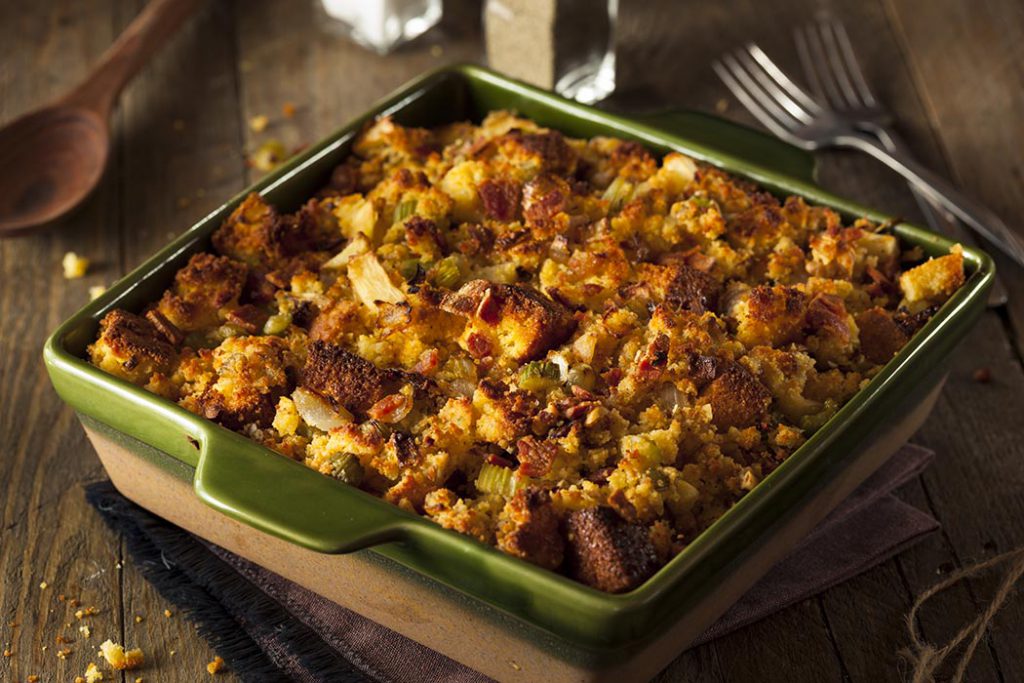 Holiday cornbread stuffing with celery and onion on a wood table