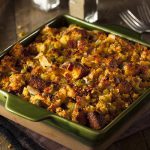 Holiday cornbread stuffing with celery and onion on a wood table