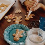 women decorating homemdae gingerbread Christmas cookies.