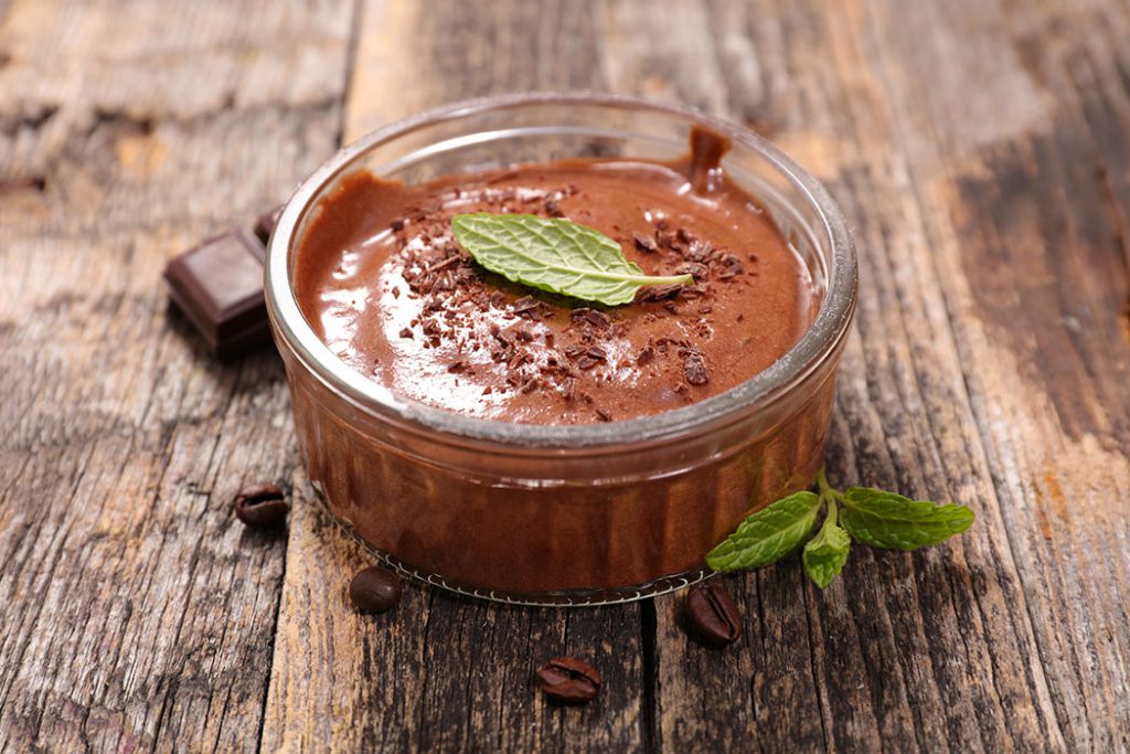 oat milk chocolate pudding on a wood background
