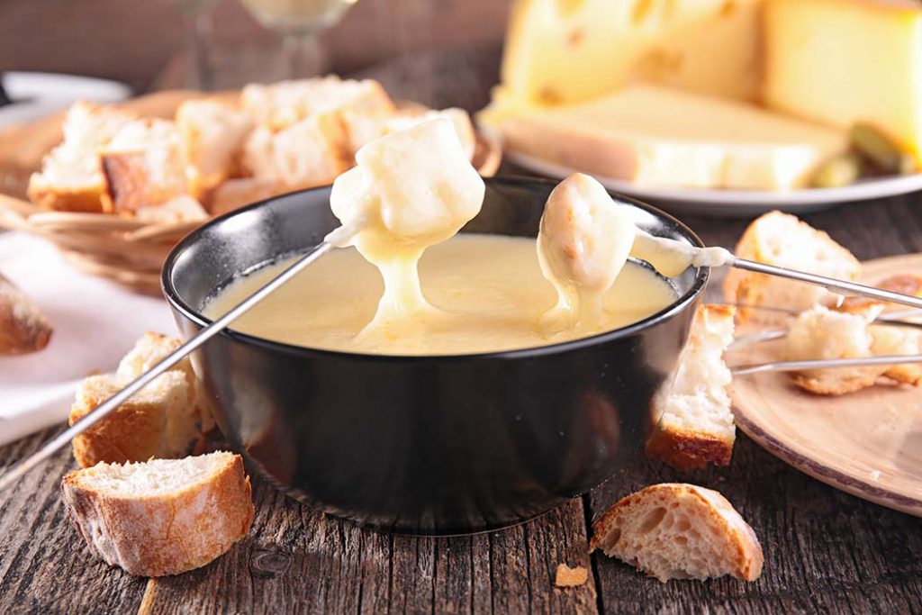 Whisky and Cheese blend wih bread sticks being dipped into for a fondue dinner.