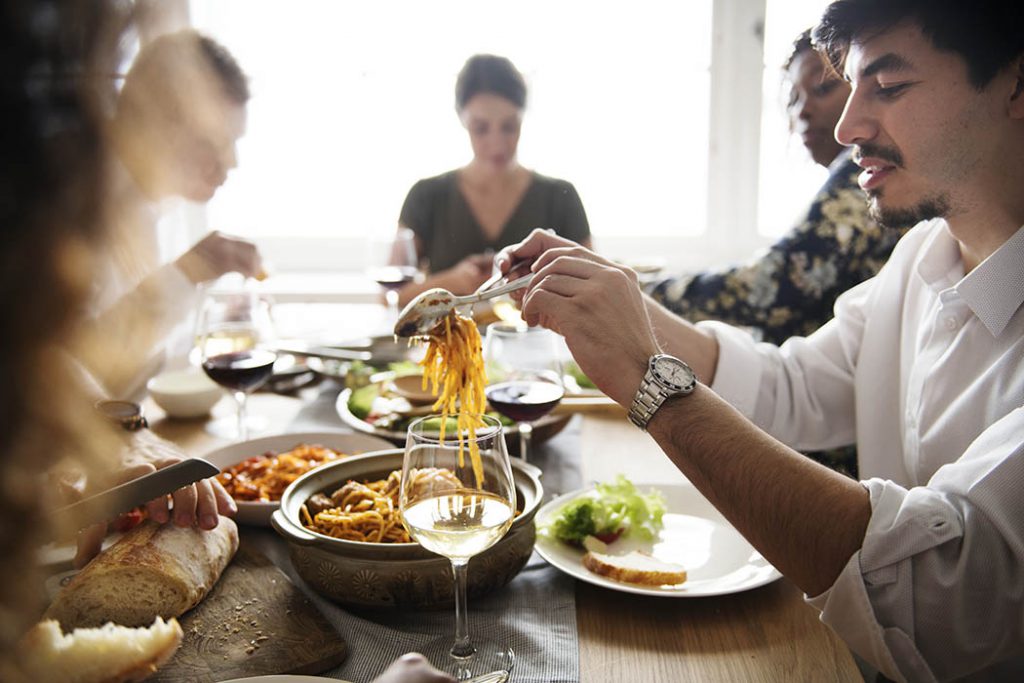 Friends gathering having Italian food together