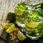 Mojito cocktail and ingredients, rustic wood background, copy space
