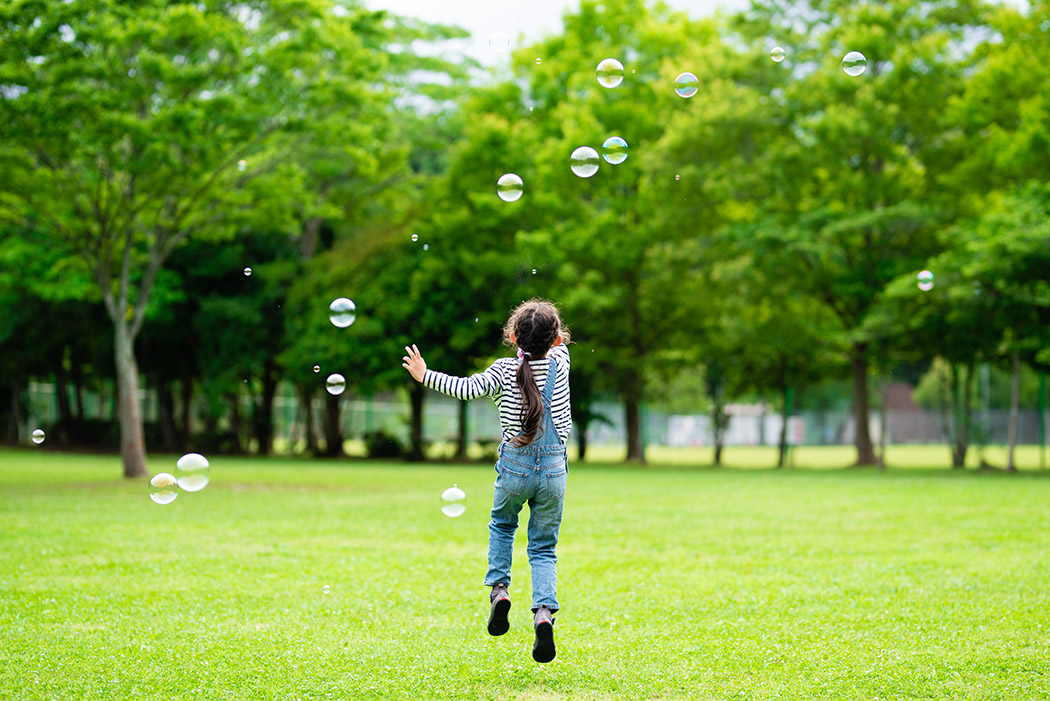 Girl playing with soap bubbles