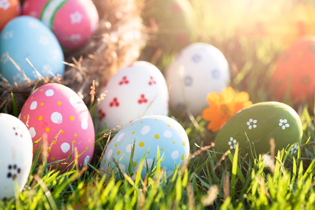 decorated easter eggs sitting in green grass.