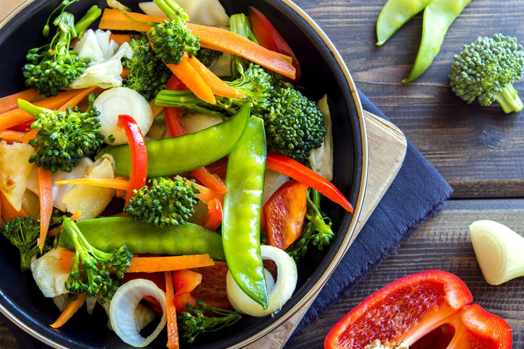 Healthy stir fried vegetables in the pan and ingredients close up