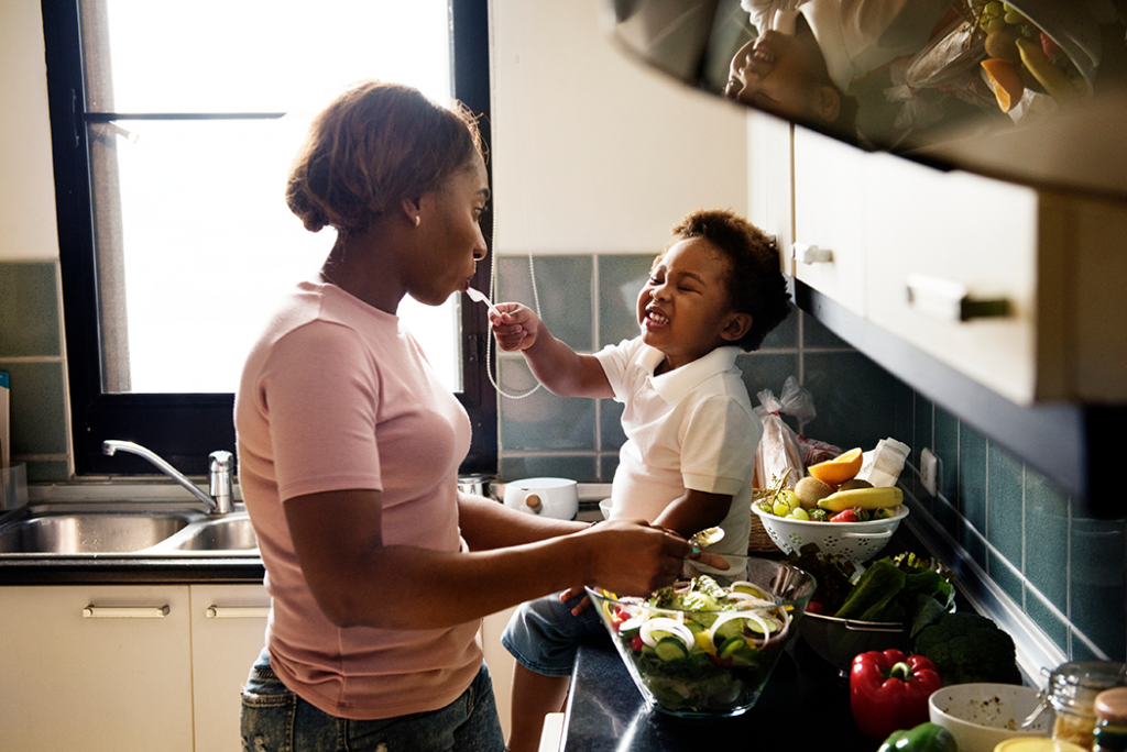 mother and son cooking in kitchen together 